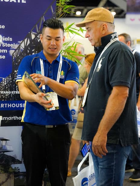 A glazing sample being demonstrated to an exhibition visitor