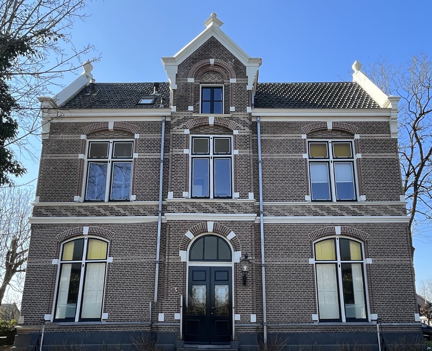 Traditional brick home with tall timber-framed windows